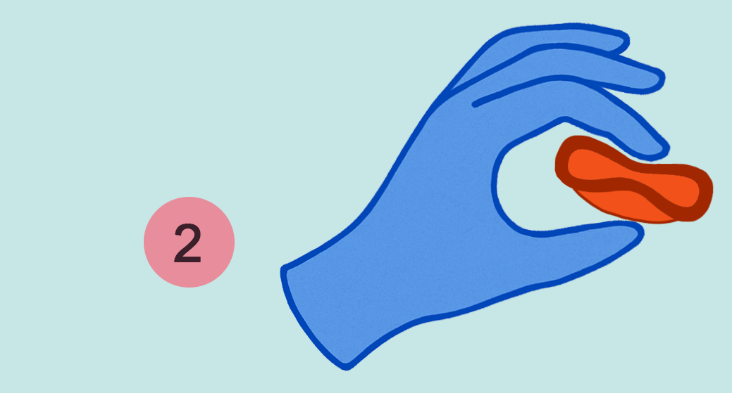 Blue hand holding and folding a red umi disc on a light blue background